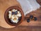 Clay bowl with dairy product cottage cheese, raisins and dried apricots on old wood table and rough cloth. Template for