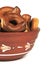 Clay bowl, a plate, a bowl, bagels, pretzels, isolate, white background