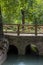 Clay brick bridge with several arches over a man-made stream