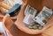 Clay broken money saving box with euro coins and banknotes. Home financial investment