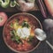 Clay brown plate and spoon with red borsch with sour cream