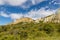 The `Clay Cliffs` at a sunny day with some clouds on a blue sky