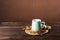 Clay cup on a wooden board on a dark background. A cup of masala tea. Spices cloves, fennel, cinnamon, cardamom, milk