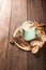 Clay cup on a wooden board on a dark background. A cup of masala tea. Spices cloves, fennel, cinnamon, cardamom, milk