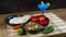 Clay dish with beef fajitas with pepper and onion strips accompanied by a plate of corn tortillas and spicy sauce, guacamole and a