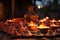 clay diyas lit up on a table outside a house