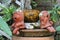 Clay doll girls sitting