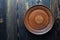 Clay empty plate on wooden background top view