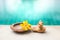 Clay Ganesh on hand with yellow flower in clay tray over blurred blue water background