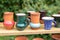 Clay glazed mugs handmade in the window at the seasonal fair masters