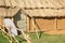 Clay house with a thatched roof and shield alongside door