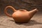 Clay jug and teapot on a background of burlap