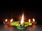 Clay oil colourful lamp diya burning on Black background with Space for text Happy diwali festival concept