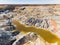 Clay Open Quarry Mars Landscape with Orange Water. Abandoned Rock Texture Old Porcelain Pit Mine in Ural. Erosion Crack