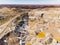 Clay Open Quarry Mars Landscape with Orange Water. Abandoned Rock Texture Old Porcelain Pit Mine in Ural. Erosion Crack