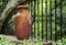 Clay pitcher pot and metal bars in colonial mexican garden