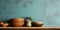 Clay plate and bowls on kitchen countertop and shelf with pottery above it. Close up background of interior design of kitchen