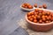 A clay plate with fresh ziziphus on wooden background