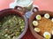 Clay pots filled with rice with boiled egg and pork rinds in green sauce, accompanied by corn tortillas