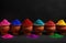 Clay pots filled with vibrant holi colors against a black background, holi celebration
