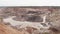 Clay quarry, aerial view. Opencast mining operations.Open-pit mine. Machinery working. Ecology and mining industry. Earth resource