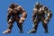 Clay and rock golems with three heads and powerful arms look up, stepping forward, 2d illustration