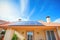 clay roof with solar panels in a sunny setting