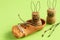 Clay shoe with jute cord, Easter rabbits made from cork and paper clips and birch twigs on light green background. Easter concept