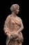 Clay statue of an ancient Greek goddess  on black background