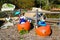 A clay statue of two women in blue dresses with a blue umbrella sitting on top of a pumpkin