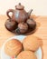 clay teapot , a cup of hot tea and bread ,gathering and talking with friends