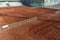 Clay tennis court in winter season. Outdoor red tennis court. Ground tennis court. Background. Space for text