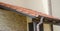 Clay tiled house roof with rain gutter under entrance home door