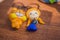 Clay toy Garfield and little girl lying flat on a wooden board