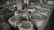 Clay workshop. On wooden shelves there are baking dishes for earthenware. Panorama back.