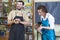 Claymaking Concept. Two Cheerful Professional Ceramists During a Process of Clay Preparation on Tables in Workshop