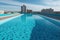 Clean and appetizing blue swimming pool ready to dive in urban surrounding. Generative AI