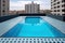 Clean and appetizing blue swimming pool ready to dive in urban surrounding. Generative AI