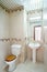 Clean bathroom with toilet and washbasin with mirror