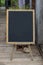Clean blackboard with easel on top of wooden floor