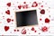 Clean blackboard with hearts on white wooden background. Space f
