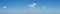 Clean blue with blobs of small clouds panorama