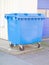 Clean blue plastic rubbish bin in urban area