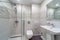 Clean bright stylish designer modern bathroom. Bathroom interior in luxury home with glass shower