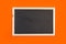A clean chalkboard on an orange background