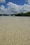 The clean clear and shallow transparent sea water off Ile aux Cerfs Mauritius on sandy beach