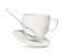 Clean cup with saucer and teaspoon in flight on background