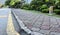 A clean curb on a quiet street, with well manicured shrubs