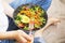 Clean eating, vegan healthy salad bowl , top view of woman holding salad bowl, plant based healthy diet with greens, salad,