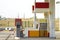 Clean empty auto gas station exterior on sunny day on rural landscape and bright sky copy space background